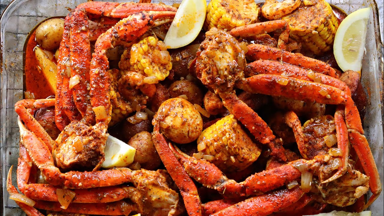 A vibrant Cajun Seafood Boil made using Birria Queen’s Cajun Bomb, featuring crab legs, corn, potatoes, and lemon wedges, seasoned with a rich blend of Cajun spices.