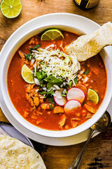 A bowl of Pozole Rojo made with a  Pozole Bomb