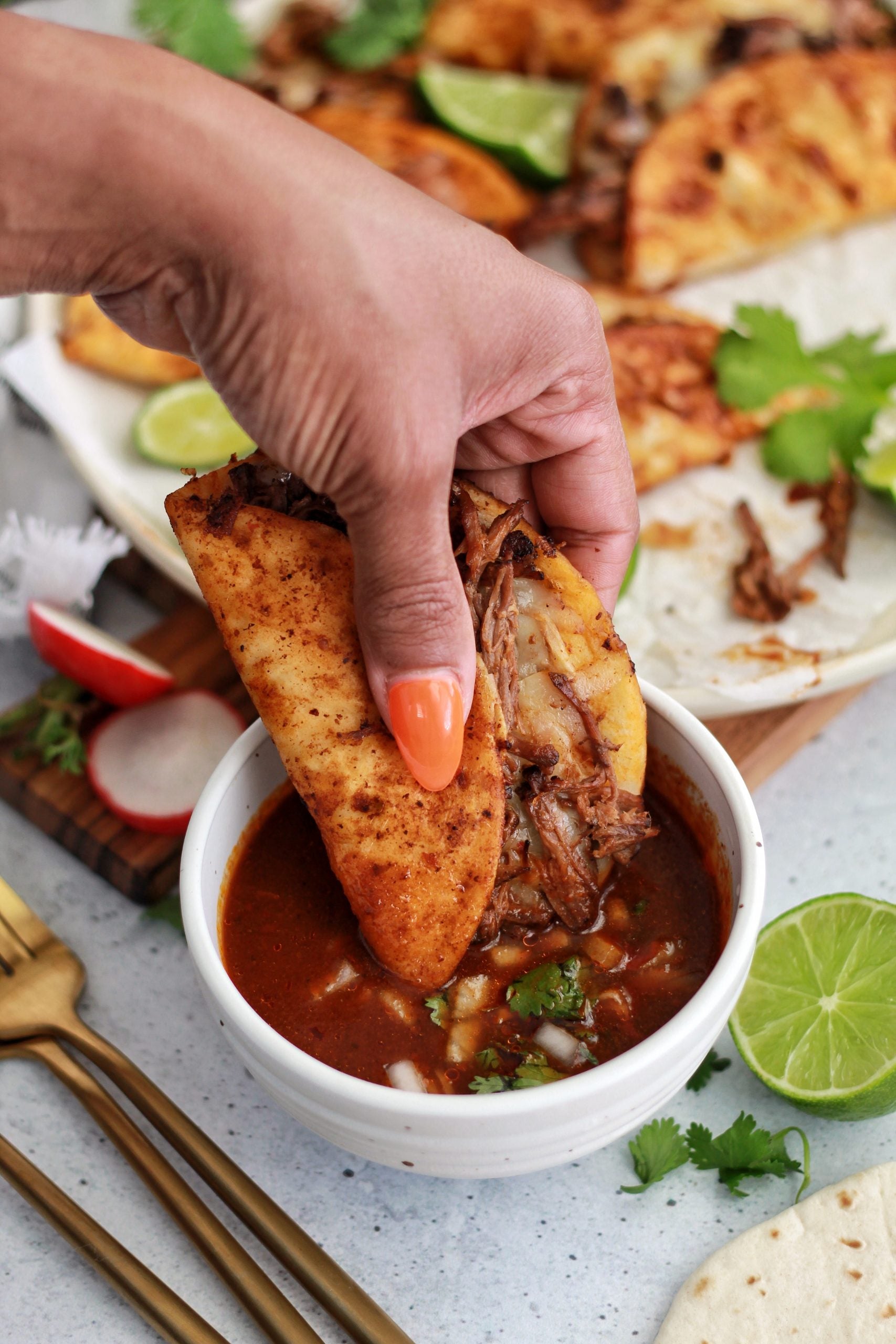 Dipping Delicious birria taco made with Instant Birria Seasoning Bomb by The Birria Queen